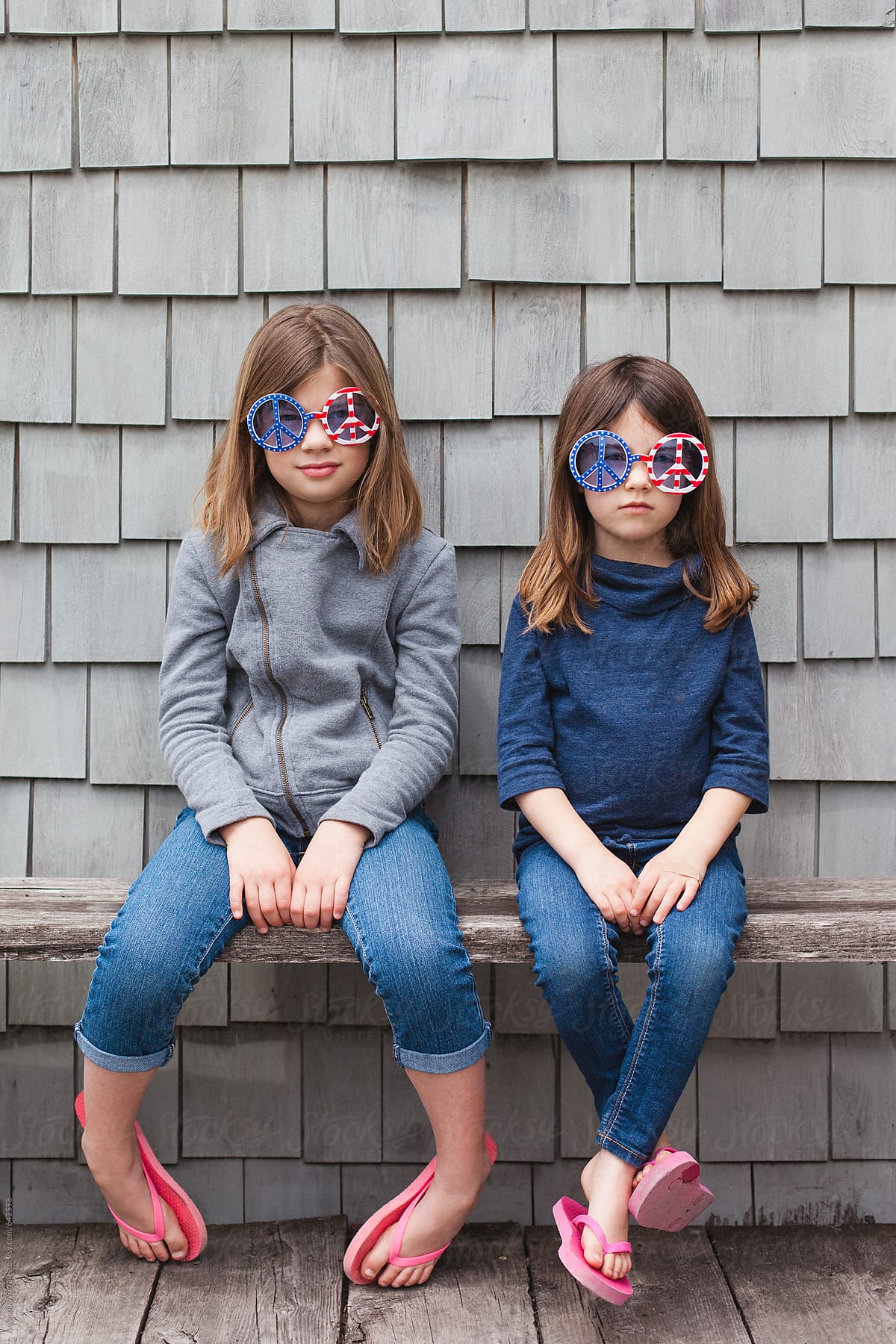Solemn Sisters Wearing Patriotic Peace Sign Sunglasses By Stocksy Contributor Amanda Worrall