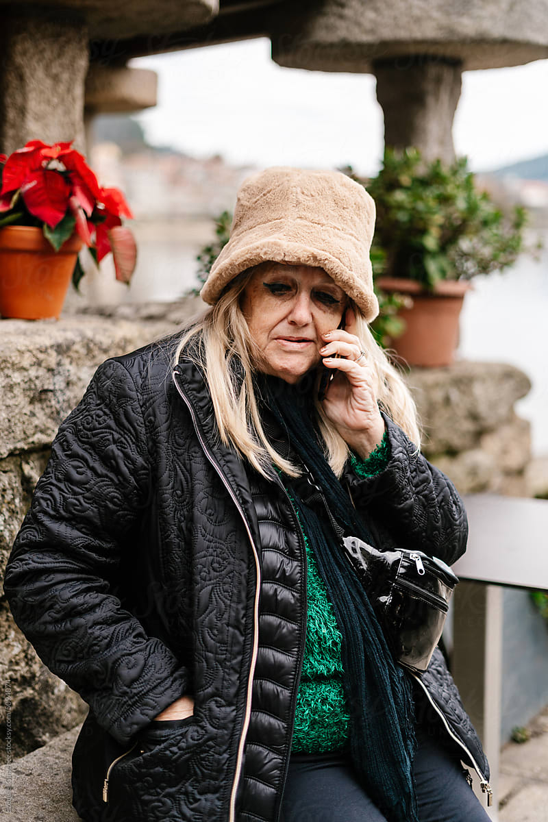 Mature woman speaking on smartphone