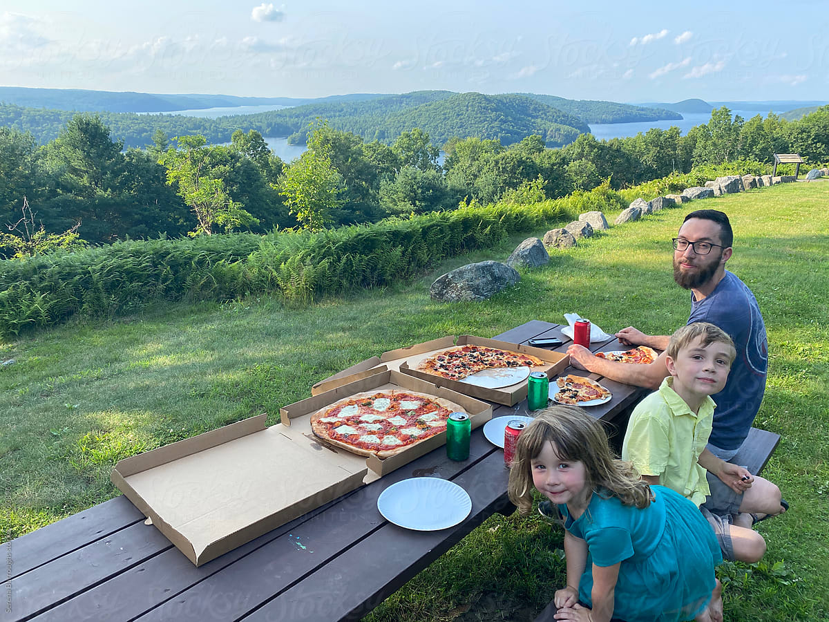 ugc iphone capture of father and children eating pizza with view