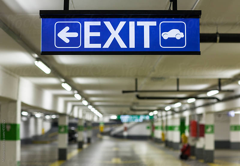 Exit Sign in the Underground Parking by Mosuno Stocksy 