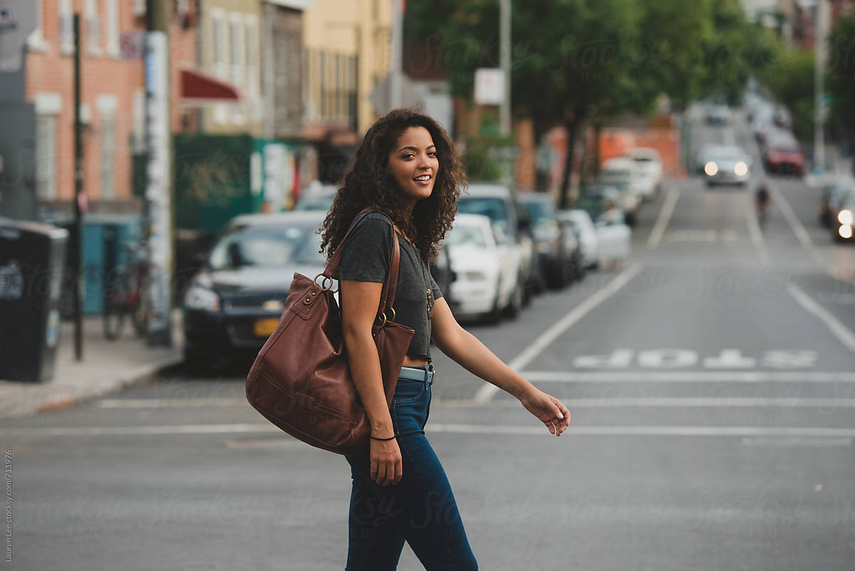 Pretty Young Woman Walking Across The Street By Lauren Lee Woman Walking Stocksy United
