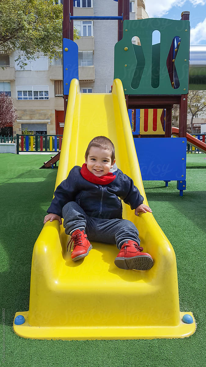Little boy sliding down the slide