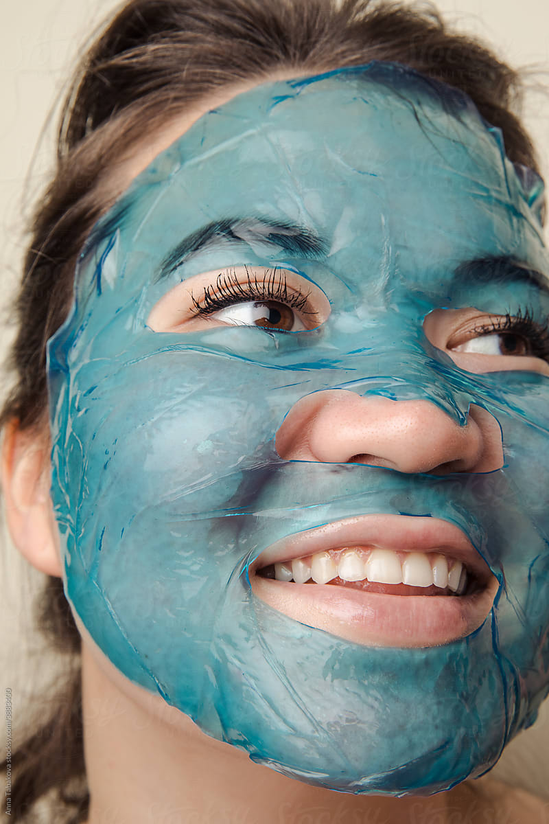 Young woman with blue face sheet mask