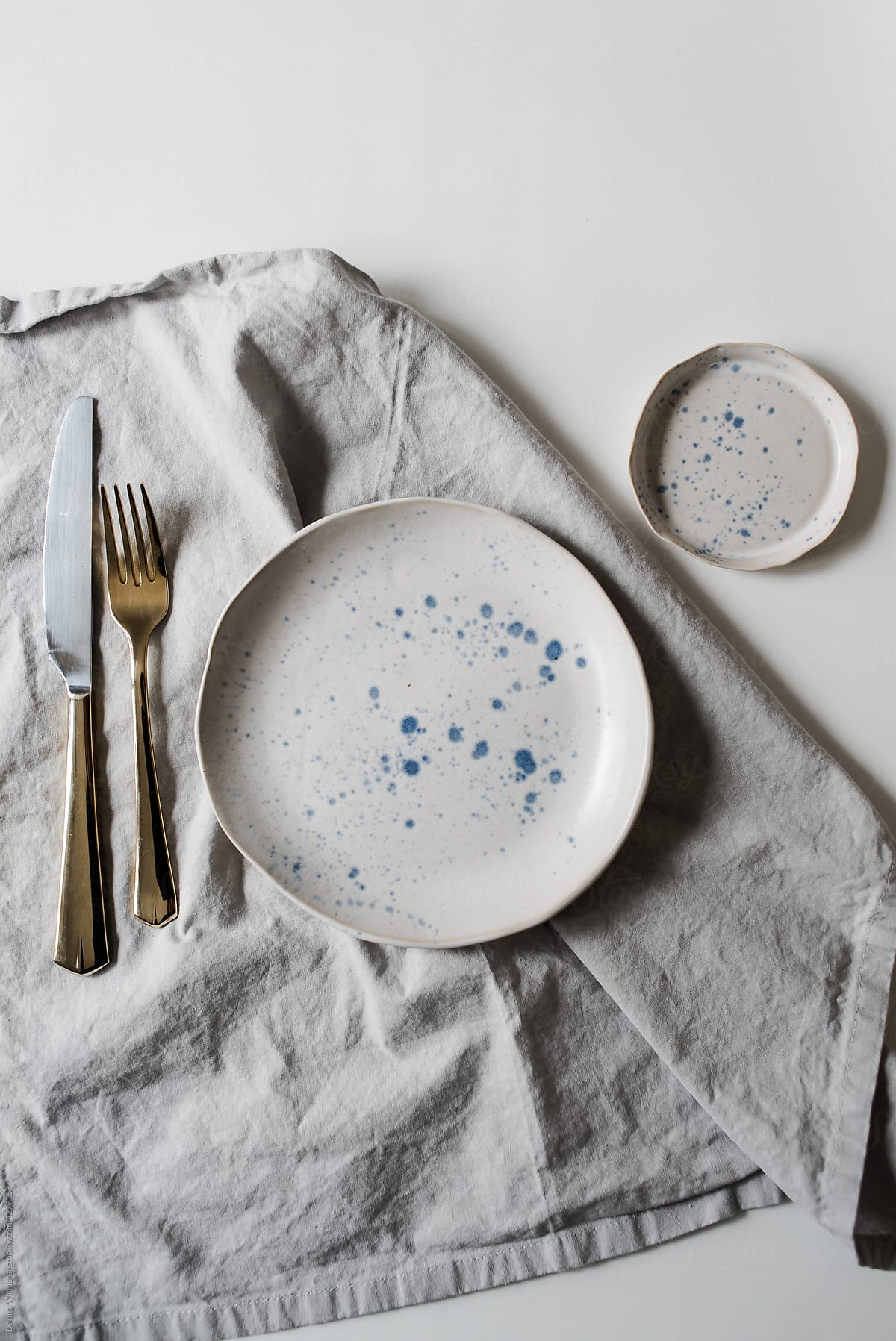 Neutral minimalist handmade plate styling on white and marble table