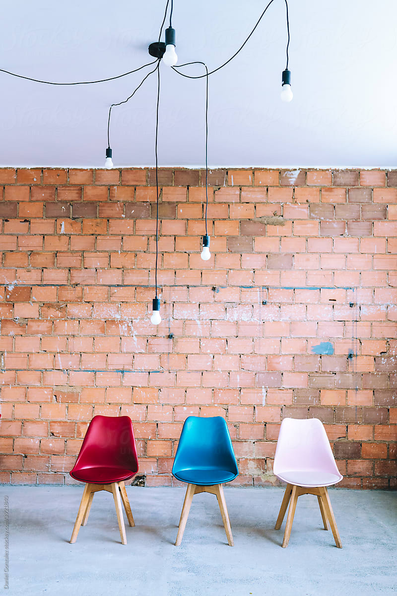 Chairs and light bulbs on industrial background