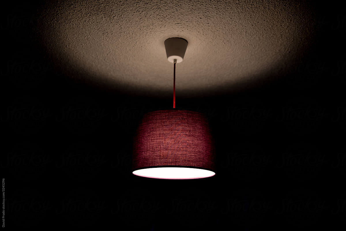 purple ceiling lamp lit in dark room