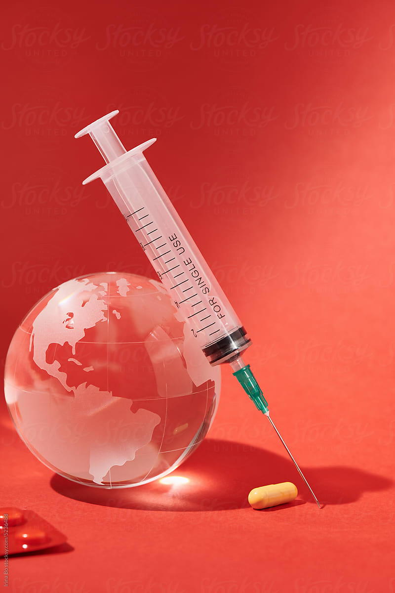 Syringe, glass globe and pills
