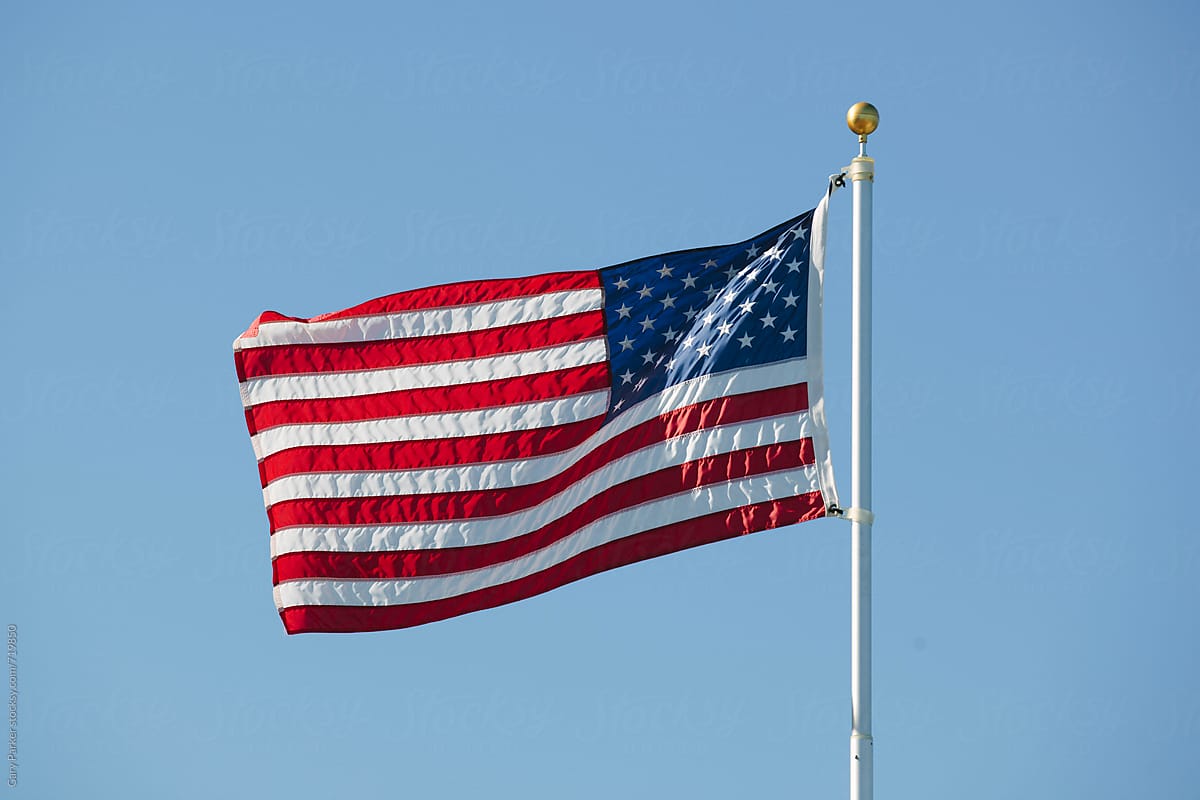 The American Flag blowing in the wind on a sunny day