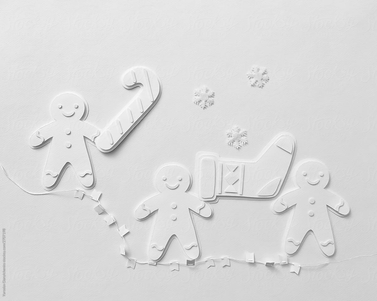 Volumetric paper snowmen, sock and garland on a gray background with copy space. Flat lay