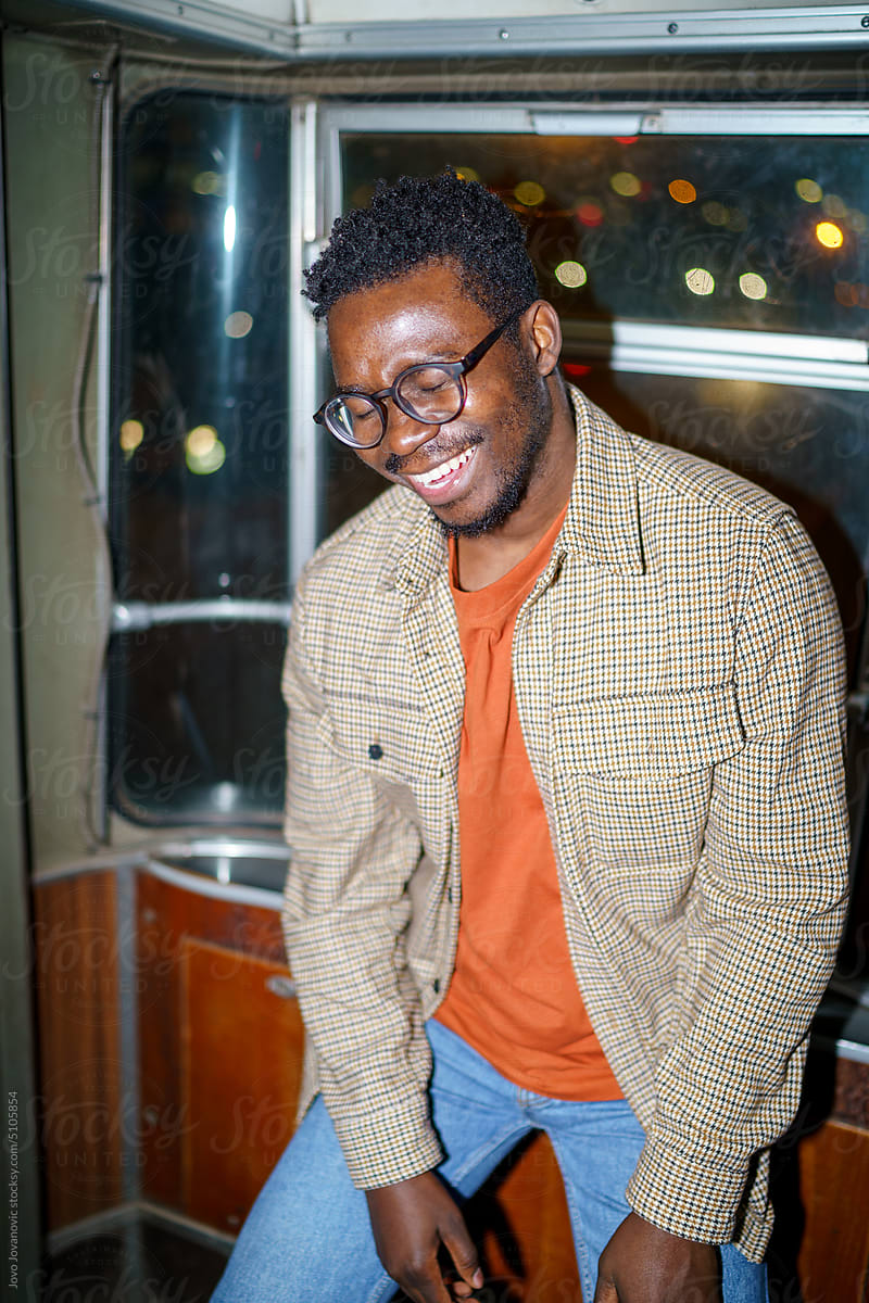 Candid photo of young black man laughing