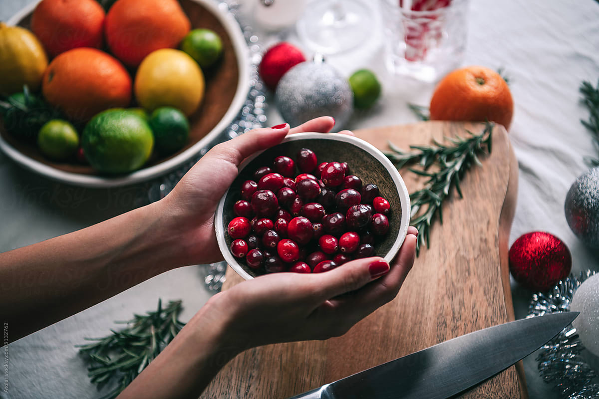Holding bowl of cranberries.