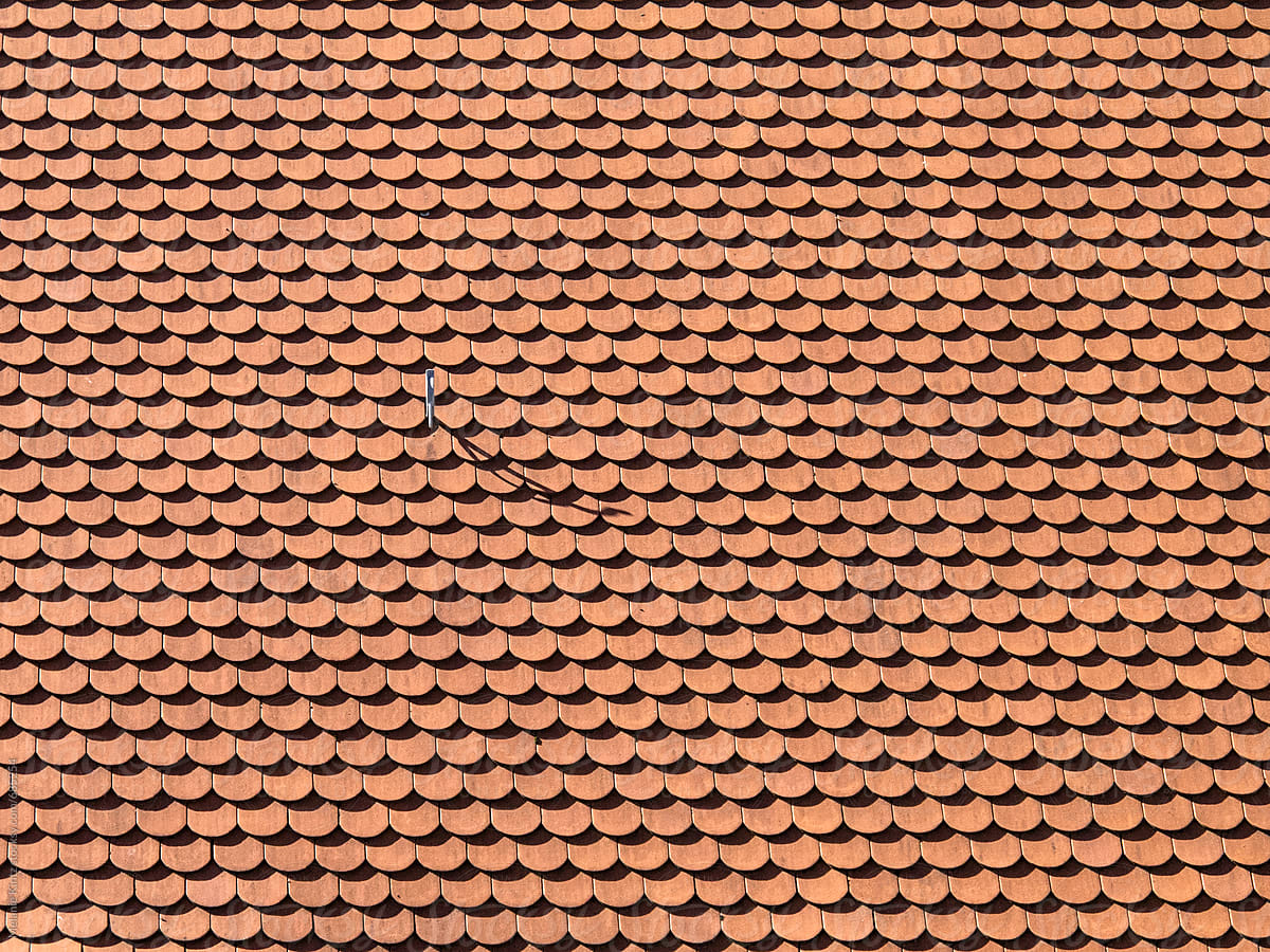 Background made from rooftiles with a hook throwing a shadow