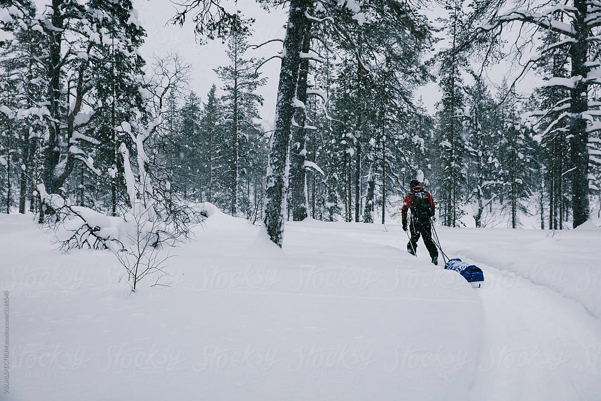 Backcountry Skier Pulling Sled in Heavy Snowfall