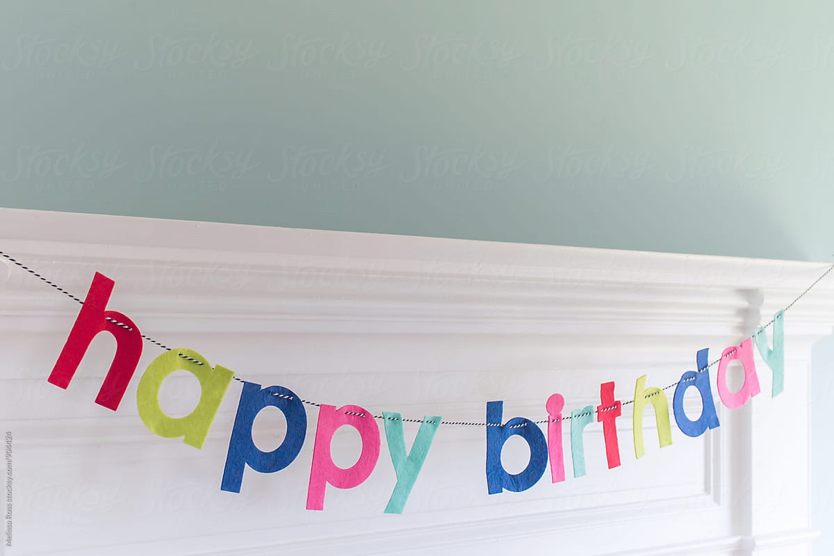 Mantel decorated with a happy birthday banner.