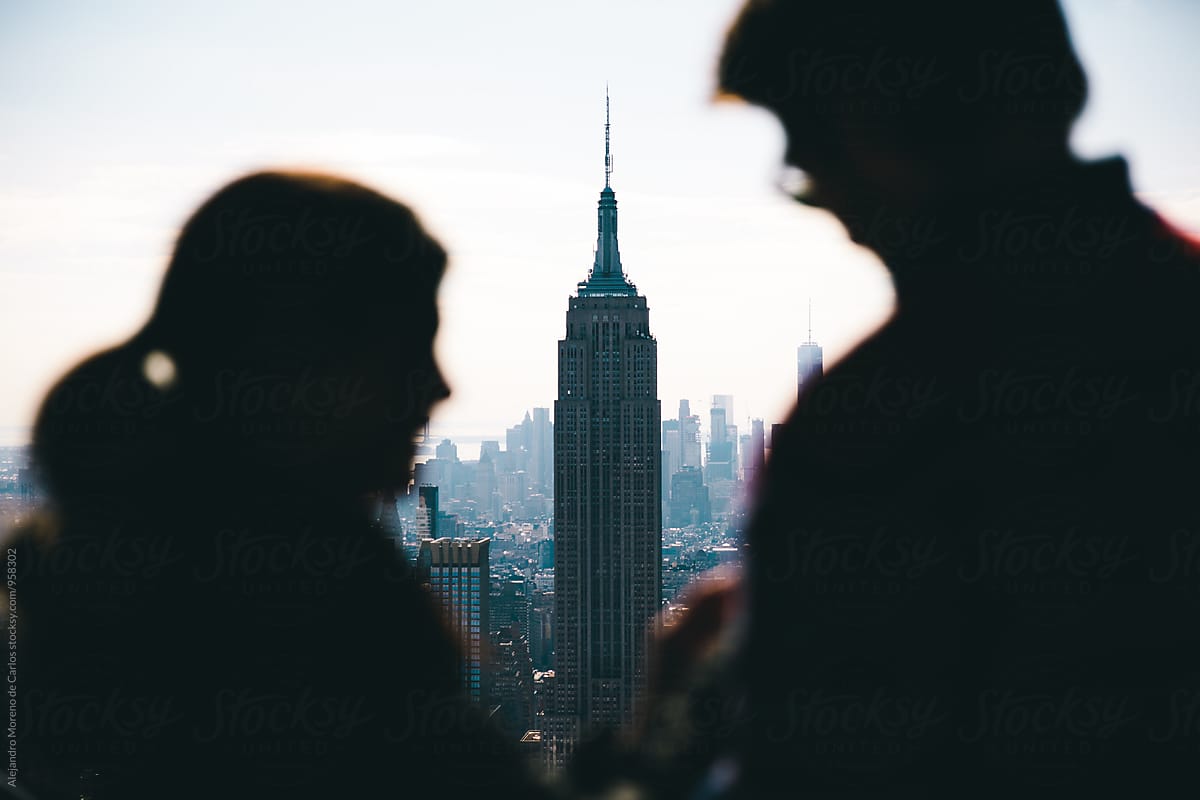 Silhouette of couple and view of the Empire State in the background. New York