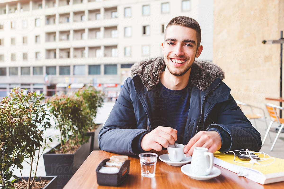 Young Man Having an Italian Espresso during the Cold Season