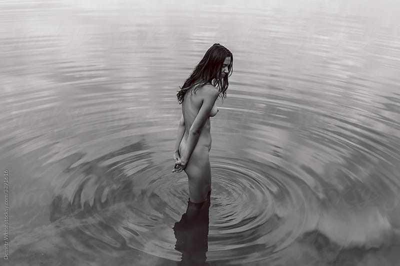 A Girl Without Clothes Standing In The Water" by Stocksy Contributor  "Demetr White" - Stocksy
