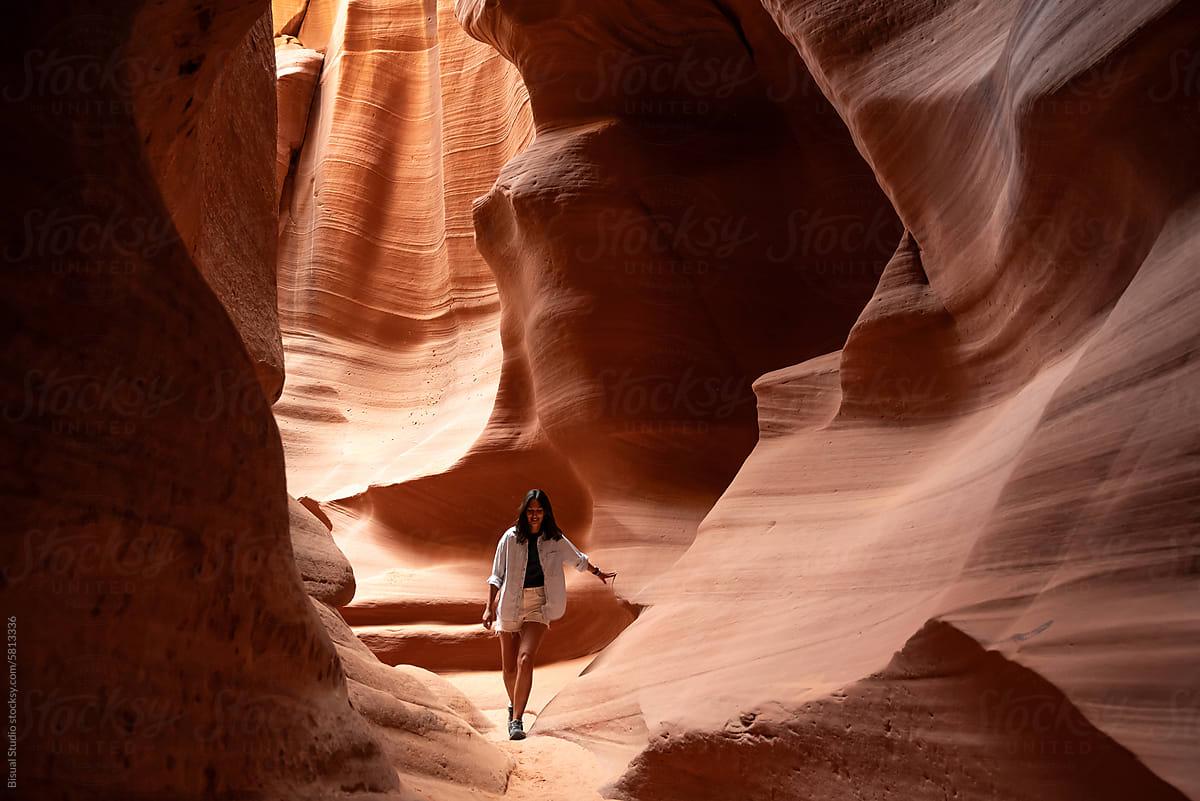 Woman walking through a narrow canyon in Arizona
