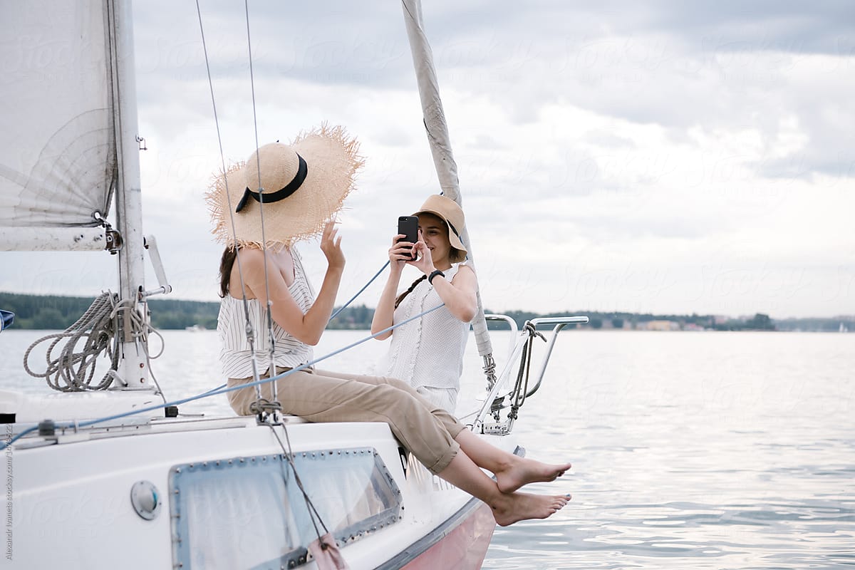 Women taking photos on sailboat