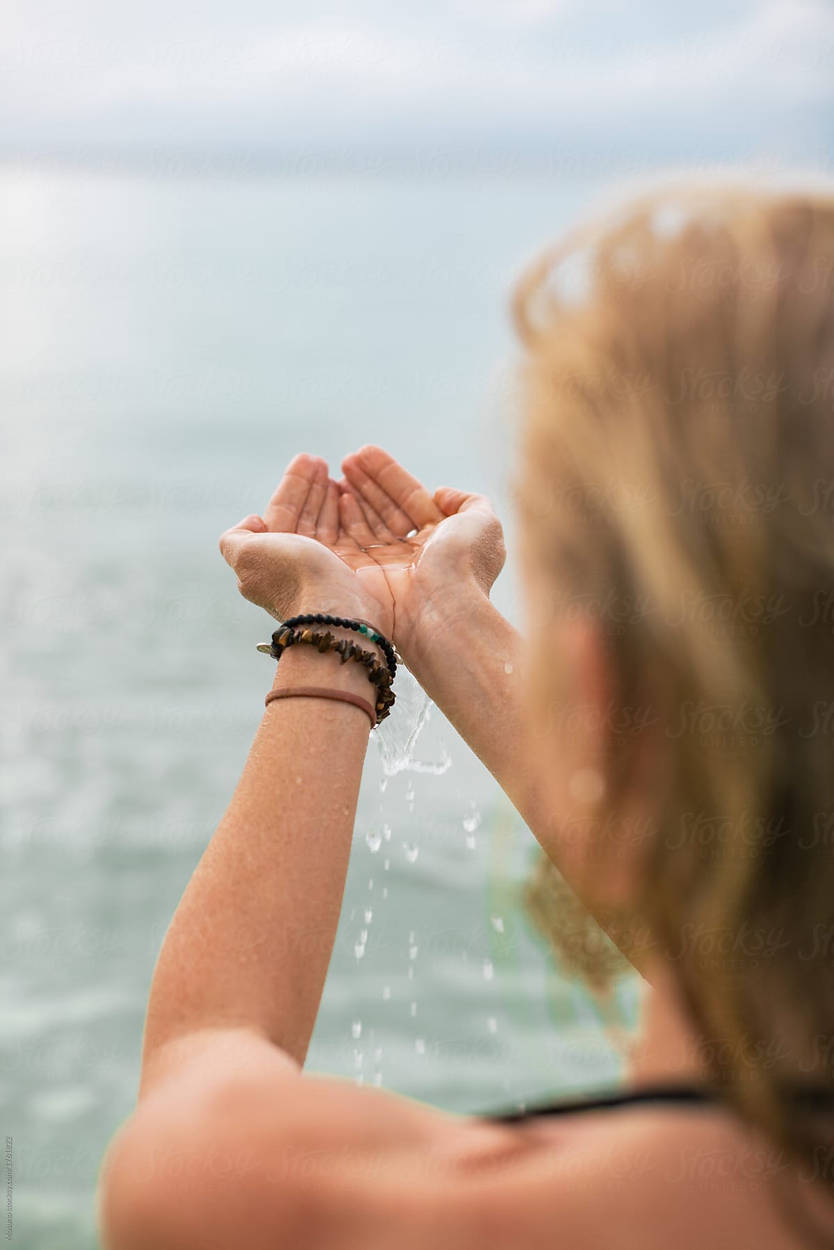Woman Holding Sea Water in her Palms