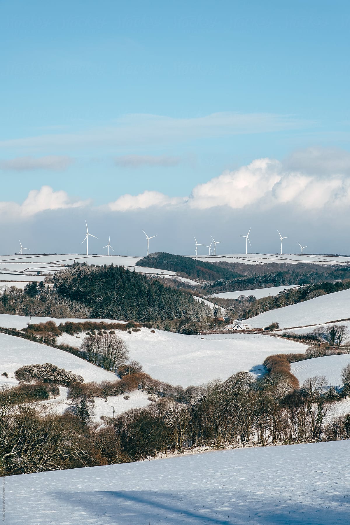 Wind farm on a snow covered hillside. Shirwell, Devon, UK.