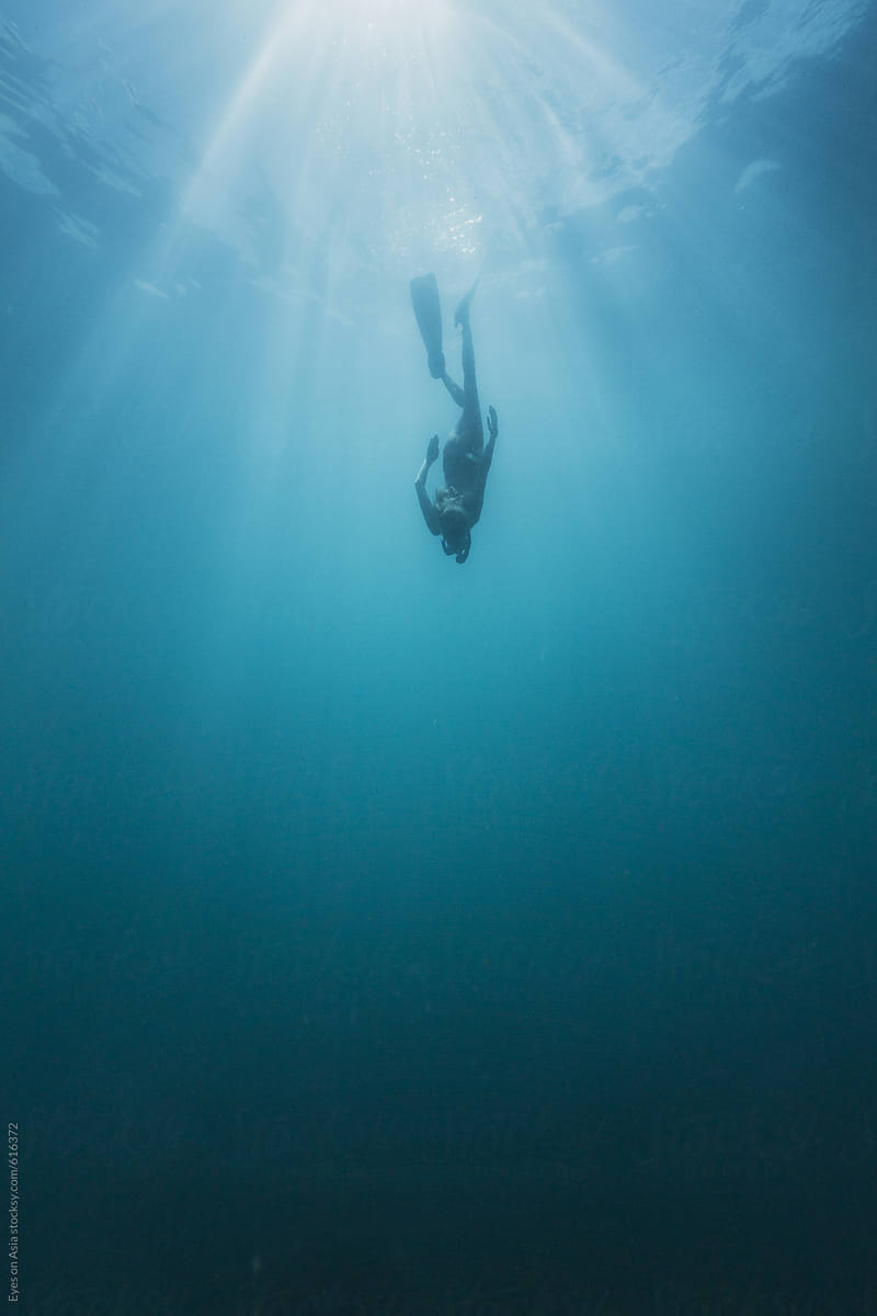 woman free diver diving underwater