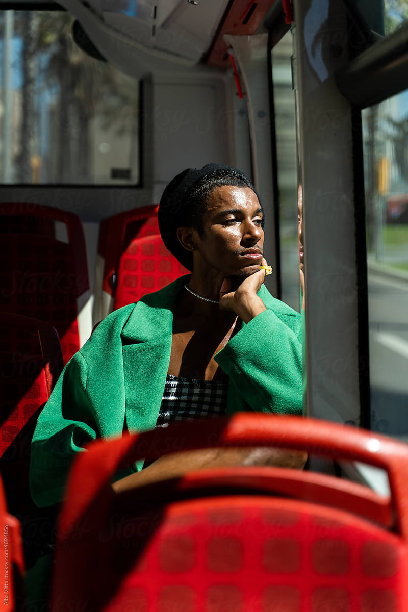 Black man traveling by urban bus