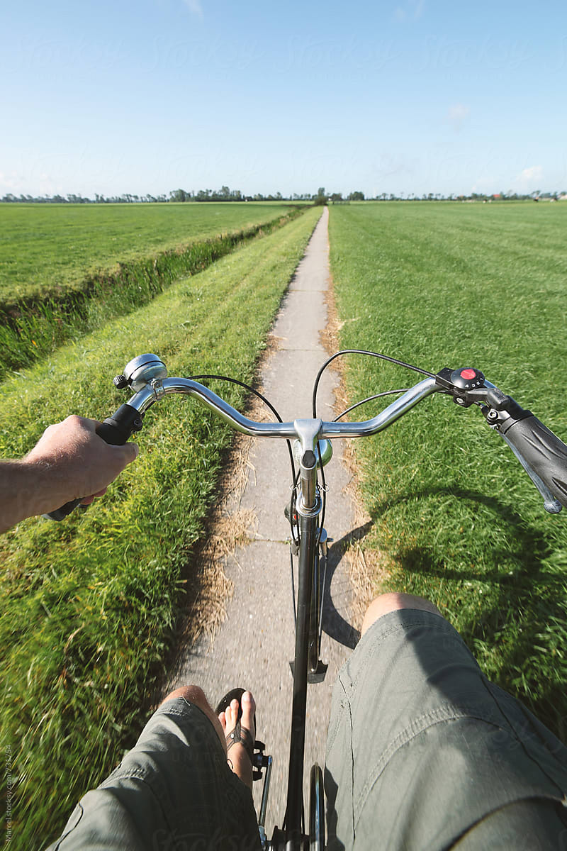 Man in shorts cycling on rural path