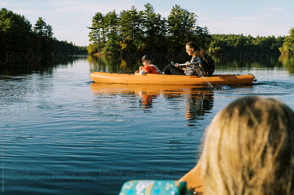 little boy in a kayak with his grandmother on a lake