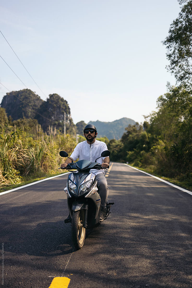 Tourist touring the roads of Southeast Asia on a scooter