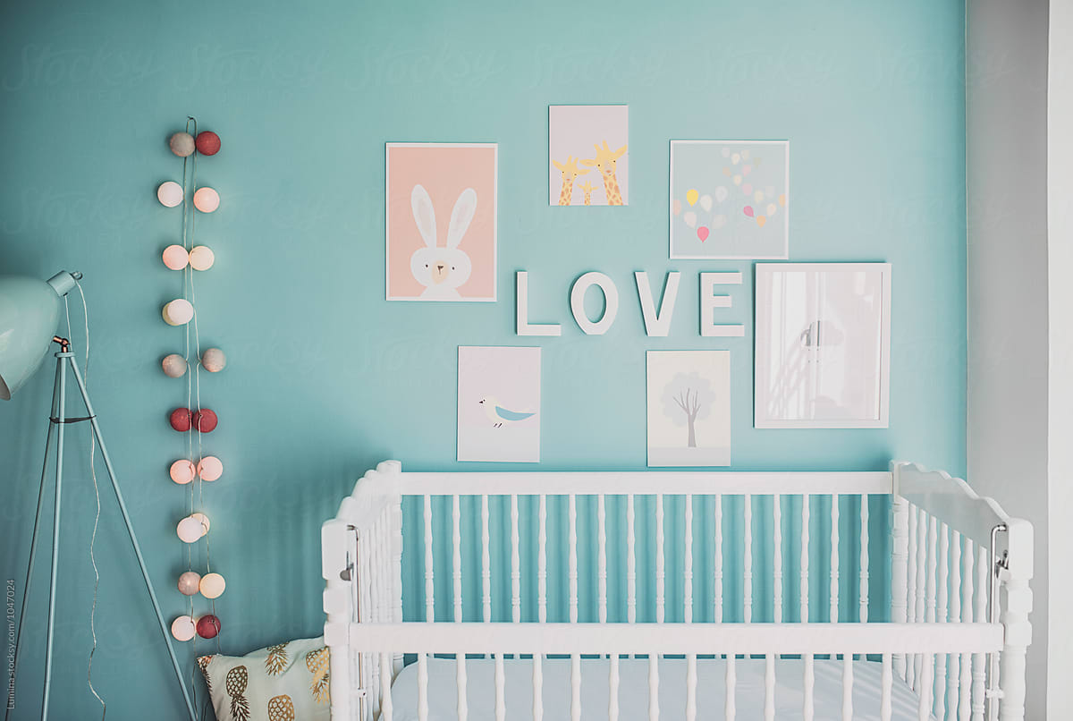 Turquoise Nursery With a Crib