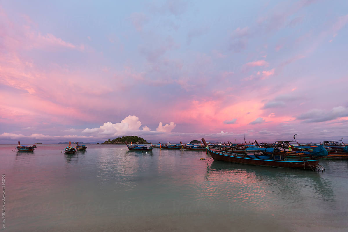 Island and boats in tropical sunset