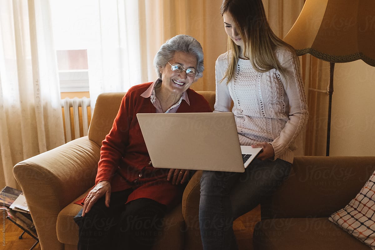 Beautiful Grandma and Granddaughter Using Computer