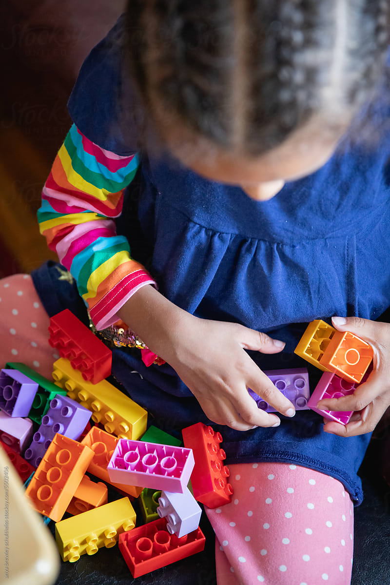 Closeup of a child\'s as she plays with lego blocks