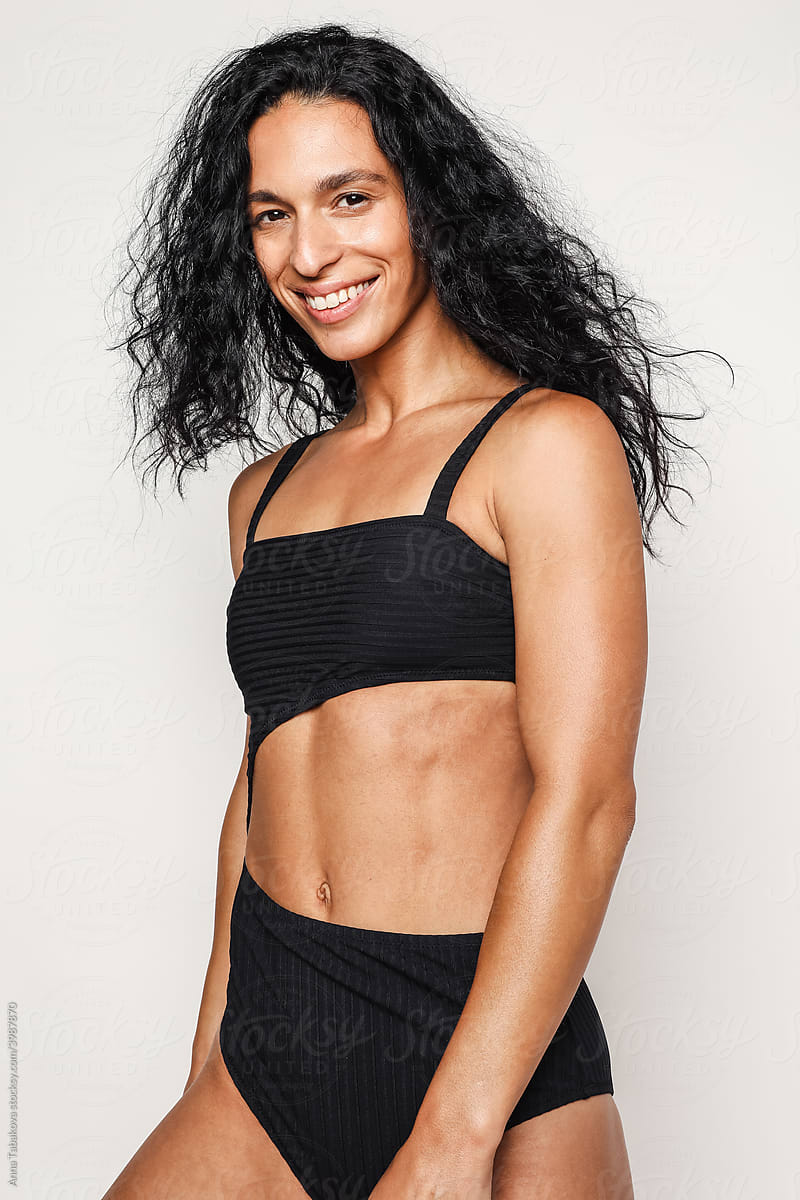 Woman In Cozy Sweatpants And Sport Bra Smiling by Stocksy