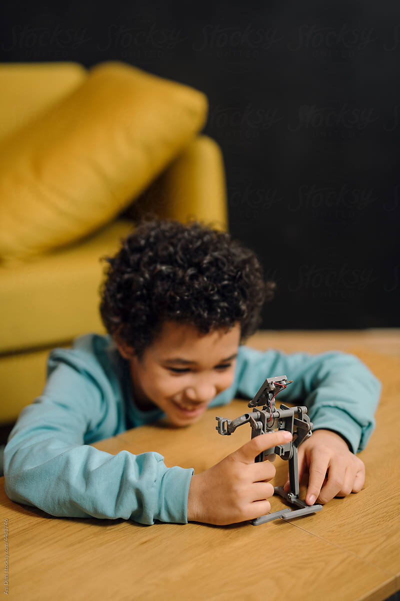 Boy plays with robot toy