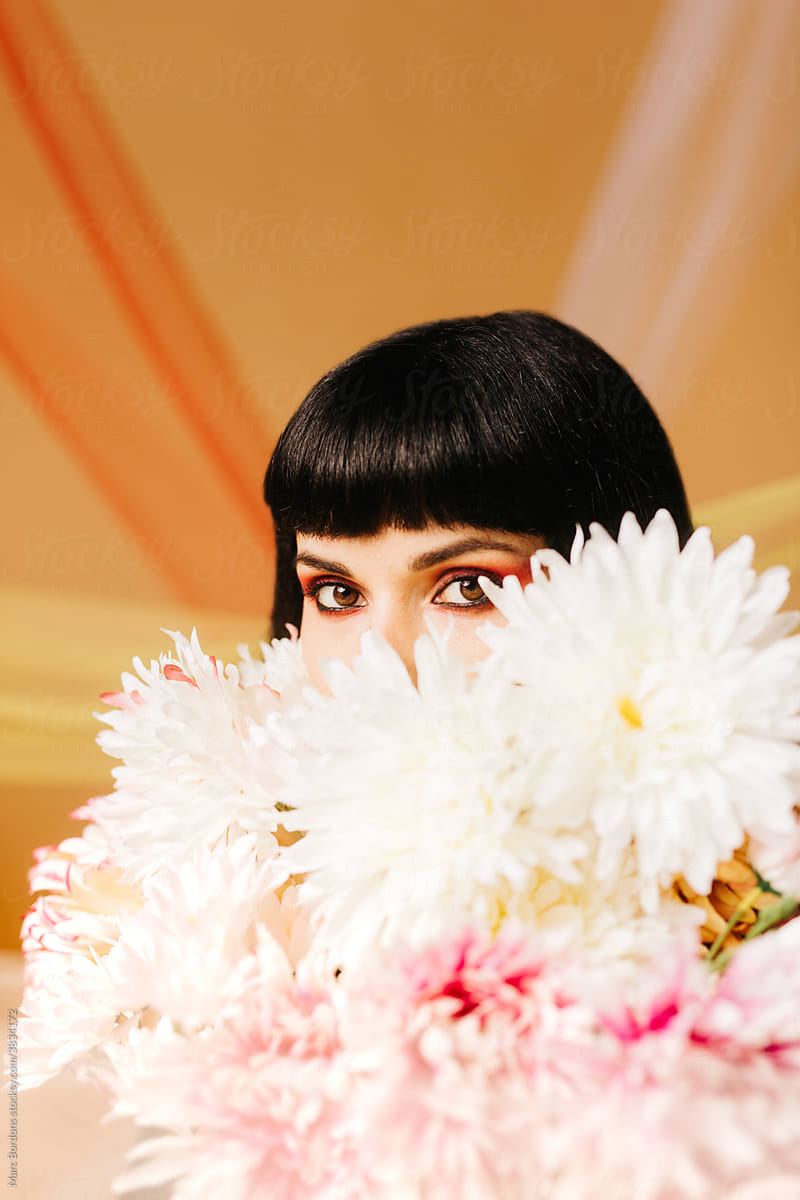 Hidden girl hiding behind a bouquet of flowers