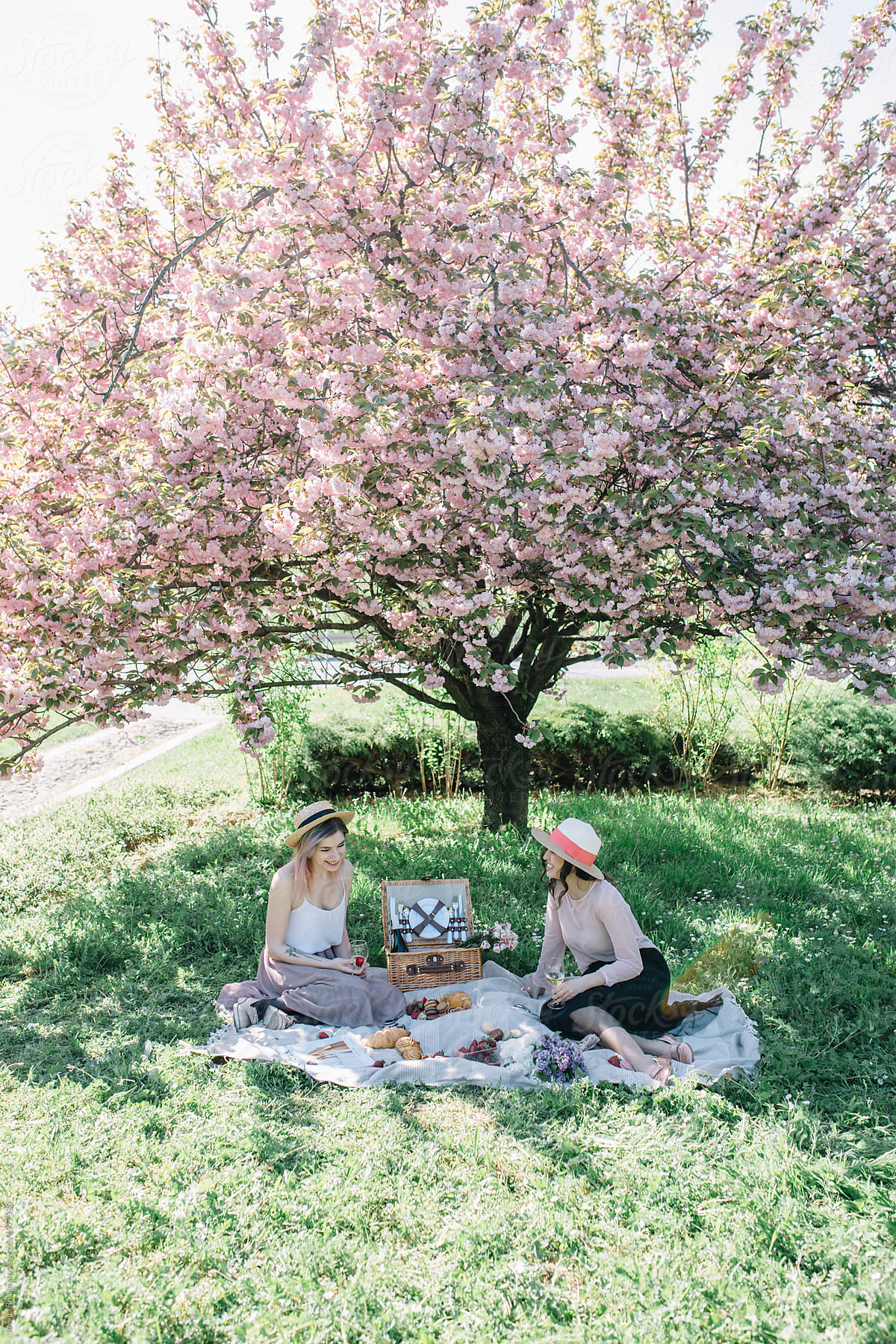 Two Female Friends Having Picnic In Nature By Stocksy Contributor