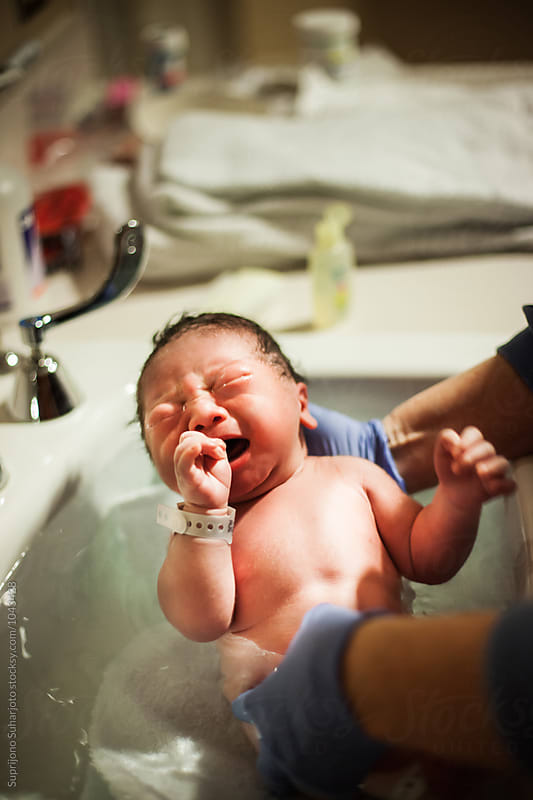 Asian newborn baby taking a bath for the first time at the hospital