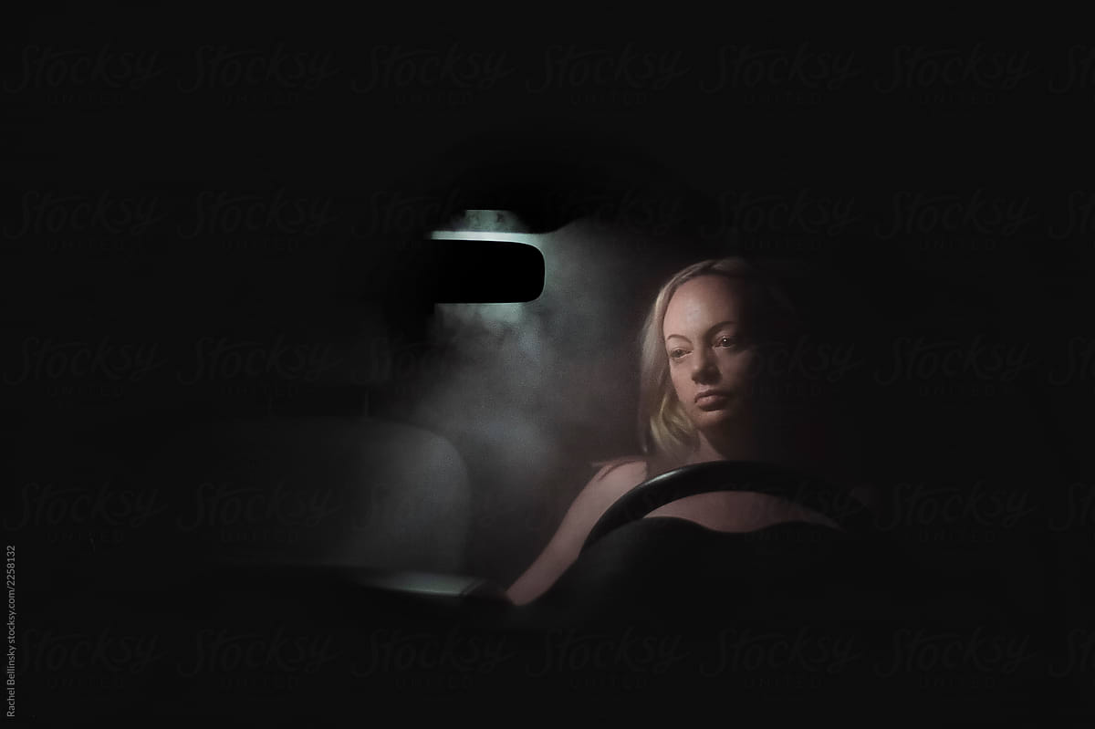 A woman in a smokey car