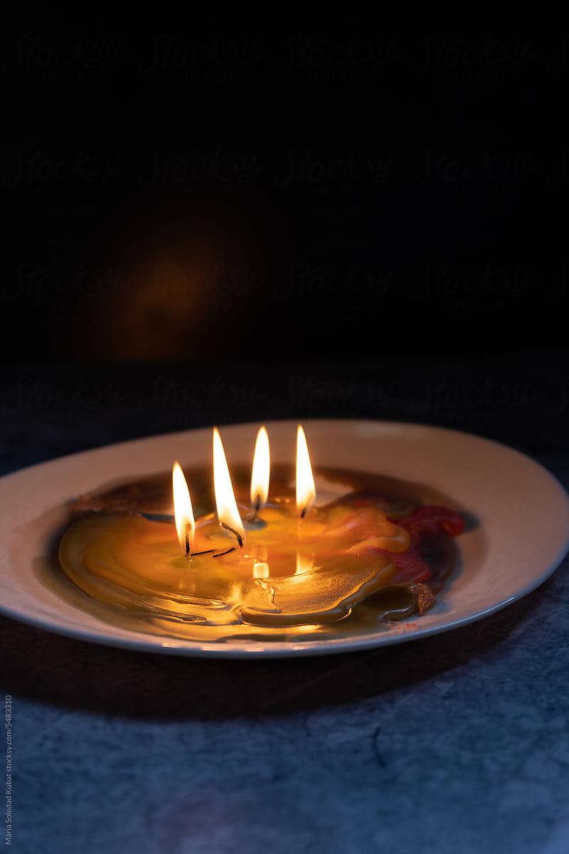 Melting candle on plate