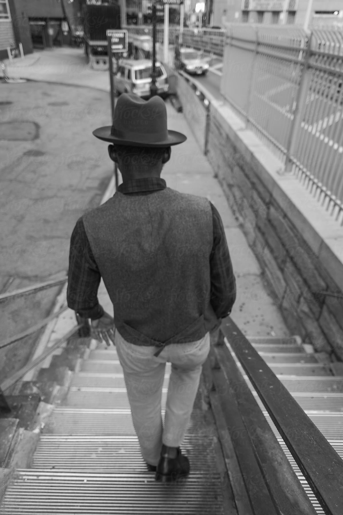 Young stylish man walking down stairs