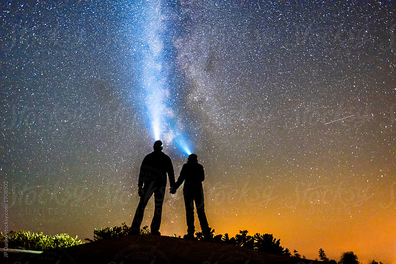 Silhouette of Couple Holding Hands With Milky Way Galaxy Night Stars and Headlamp