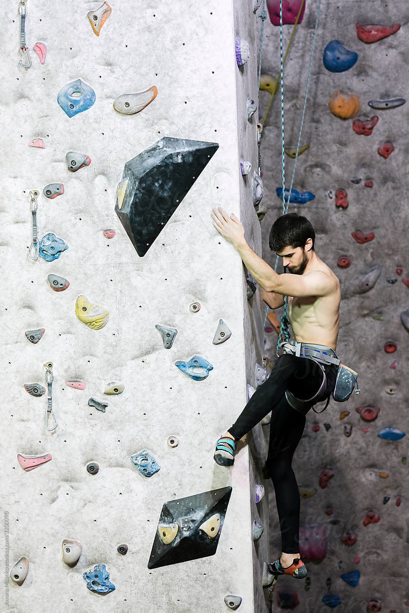 Rock climber training on indoor climbing wall