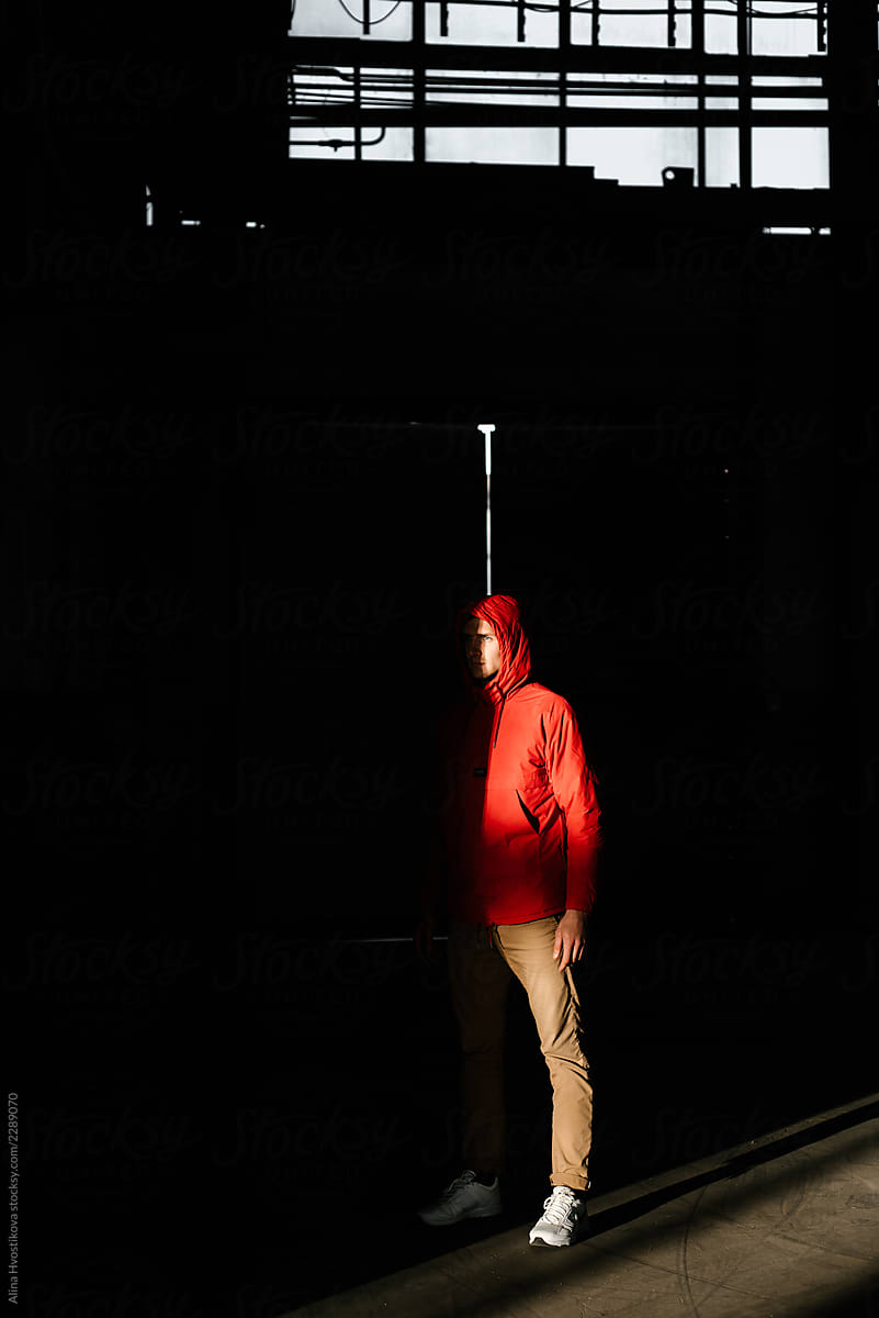 Man standing in shadow in industrial building