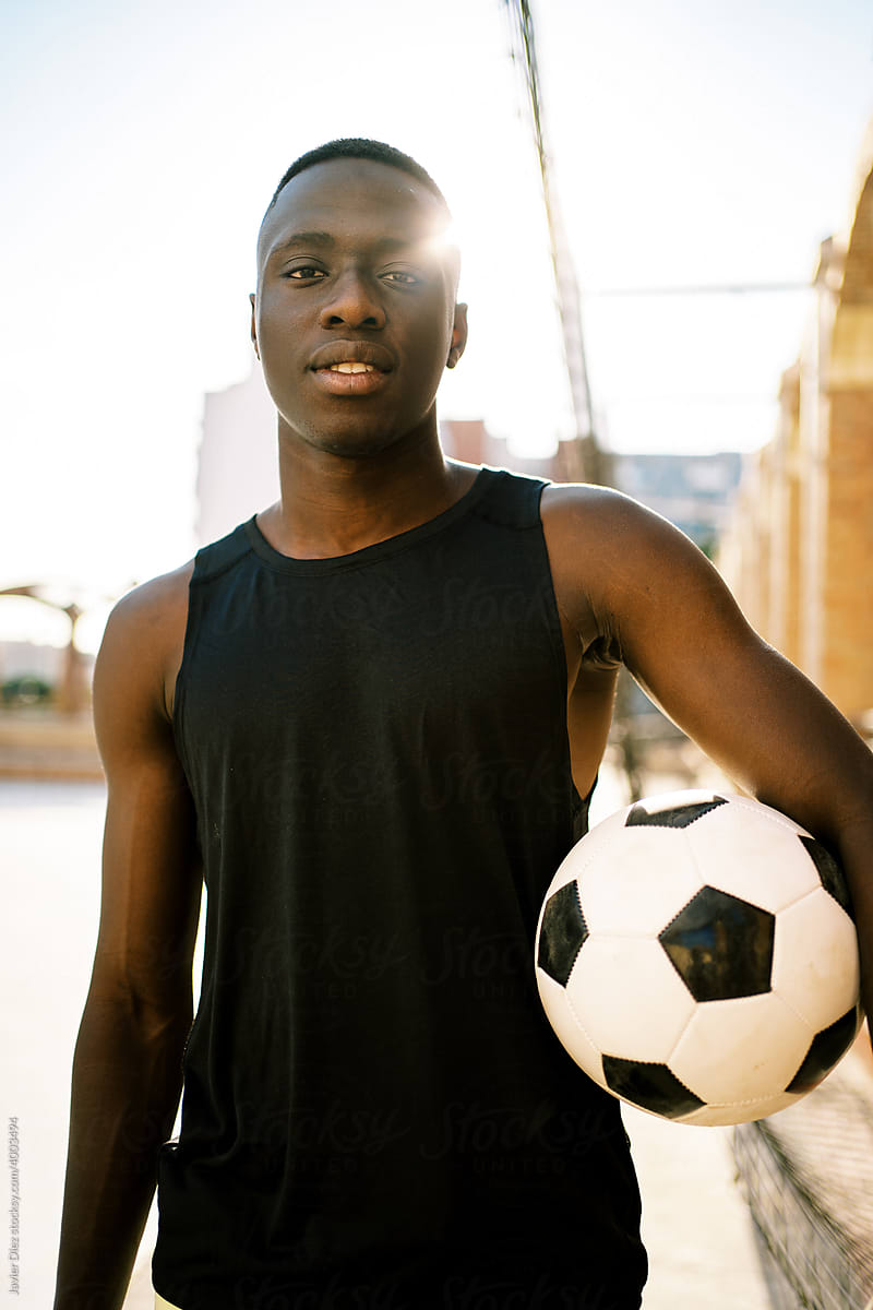 Black football player on street