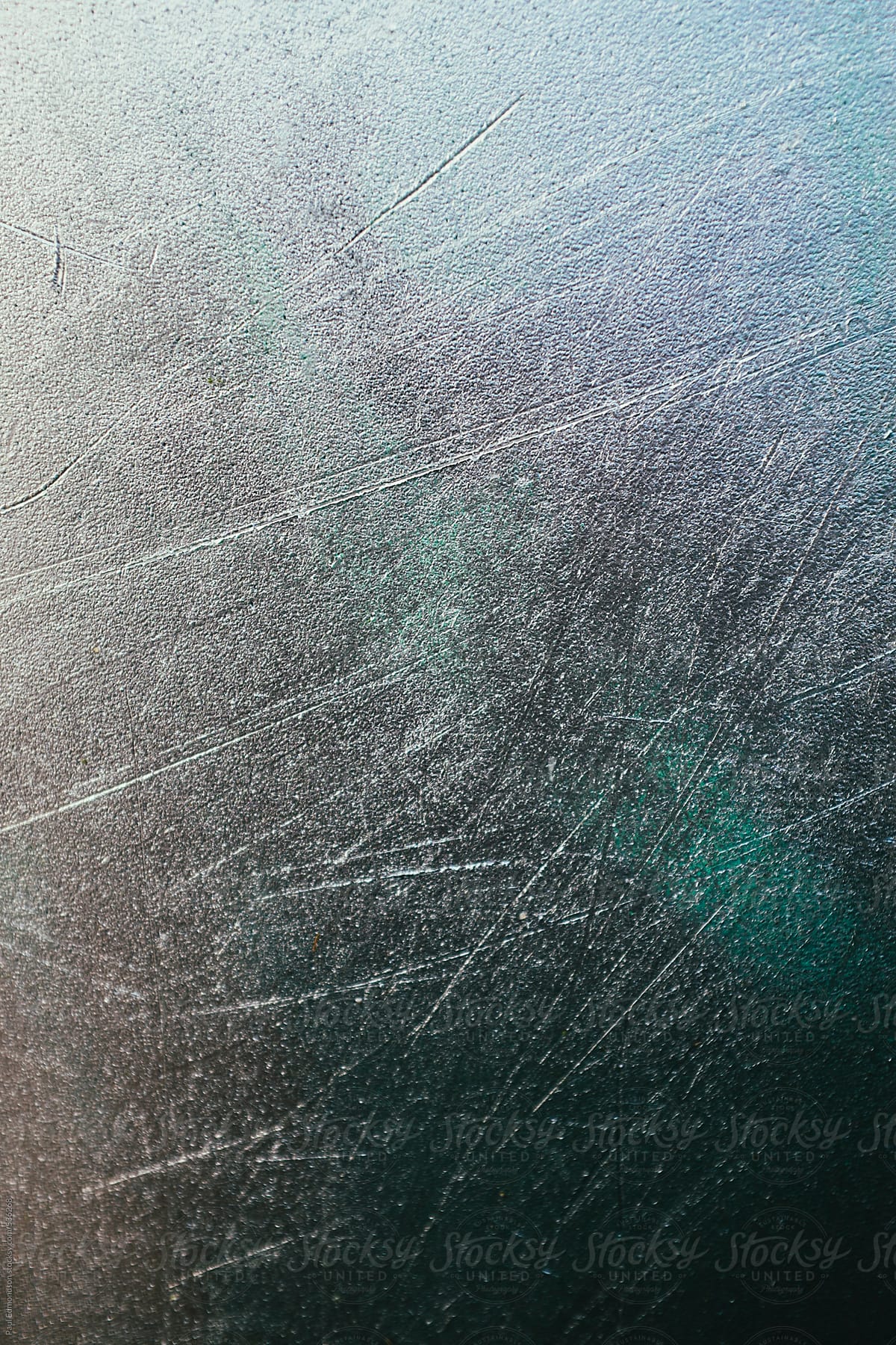 Metallic silver paint in scratched plastic surface, close up