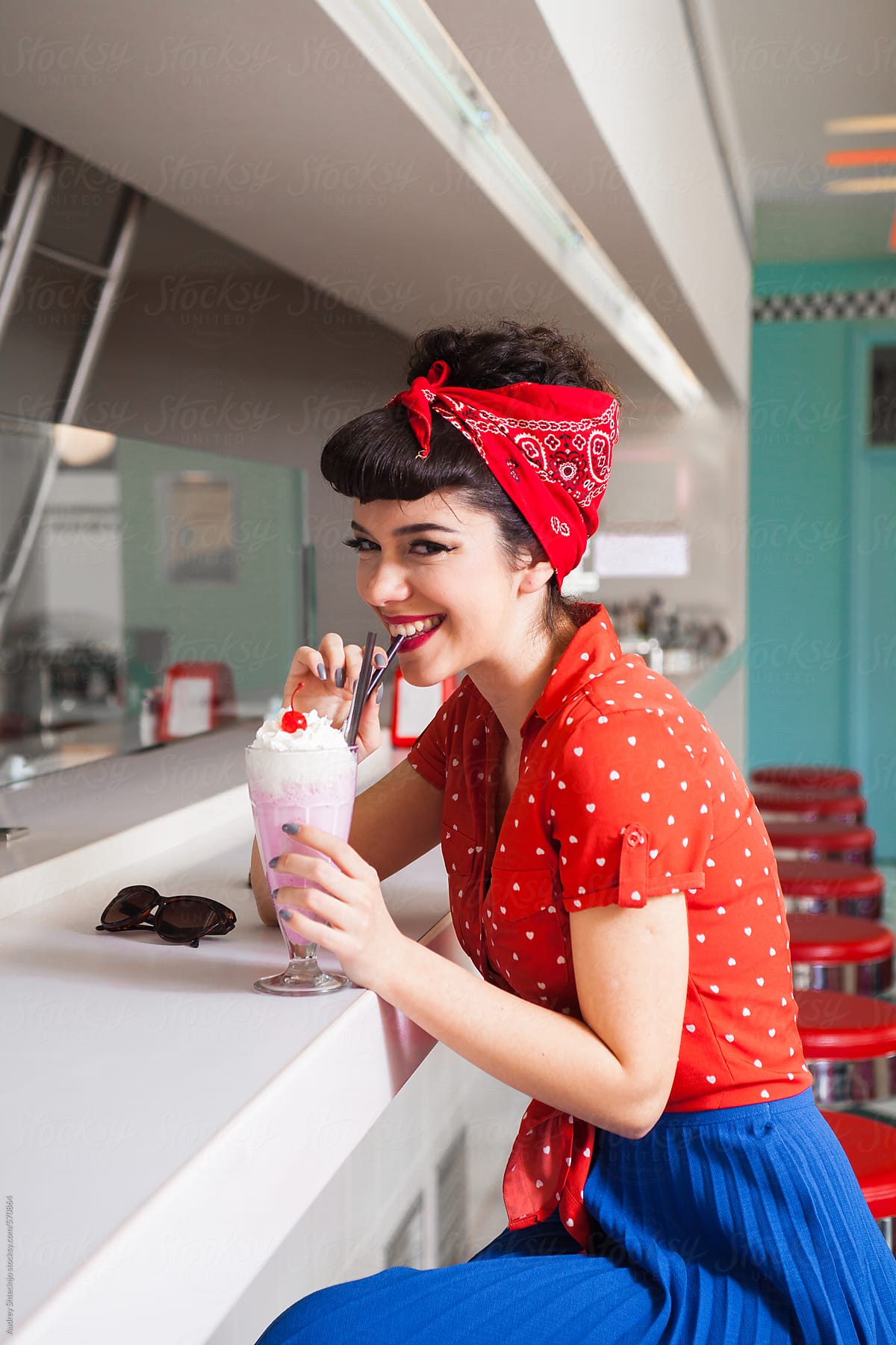 Stylish Rockabilly/pin Up Girl Enjoying Milkshake At Bar. by
