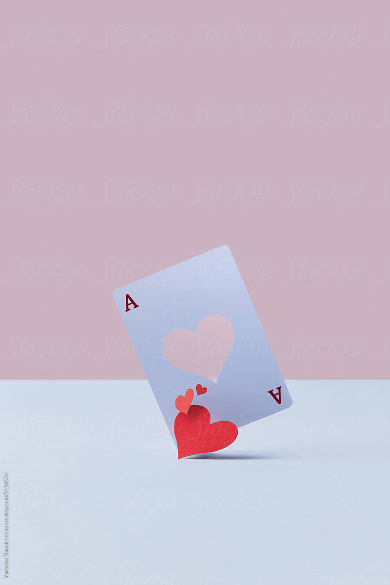 Ace card with falling out red paper heart.