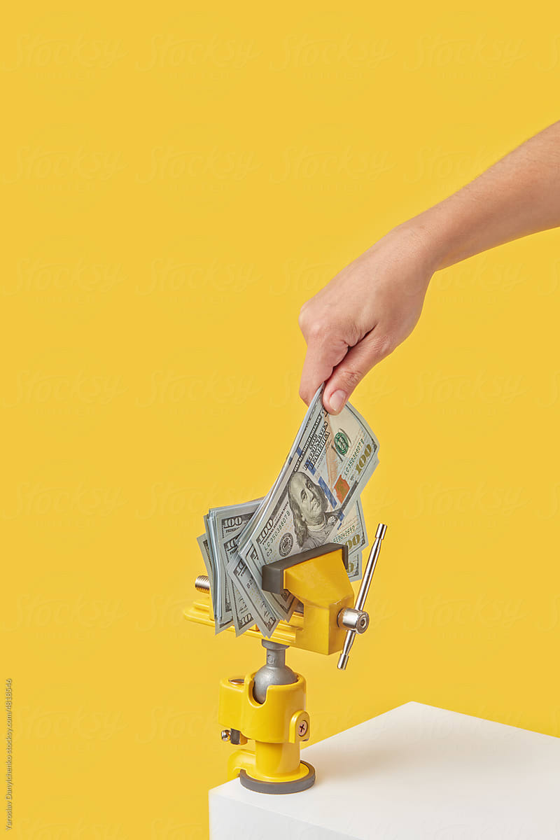 Dollars pulled by woman from clamp tool.